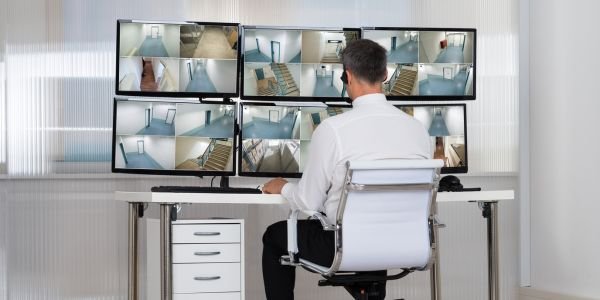 Vigilant security guard on duty in front of a modern building.